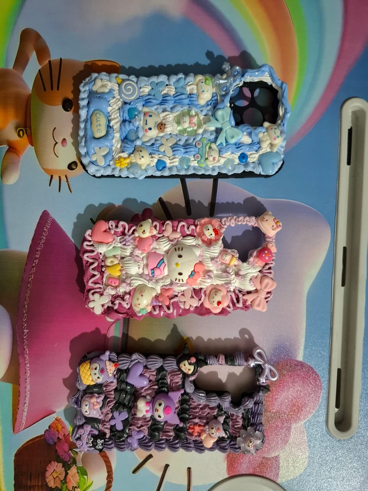 Three finished decoden phone cases lined up